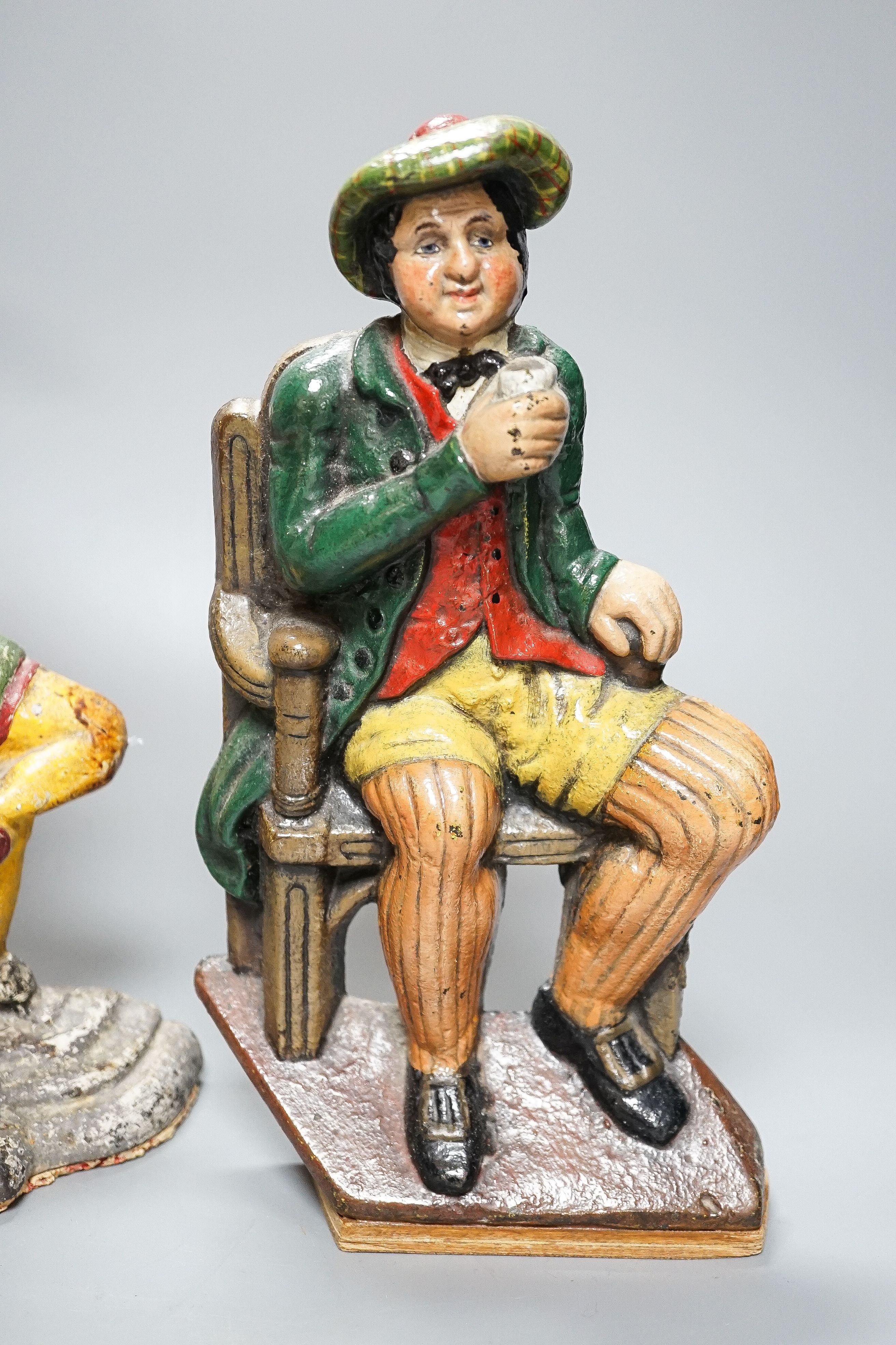 Three Victorian painted cast iron door stops (re-painted) 31cm and a later figure